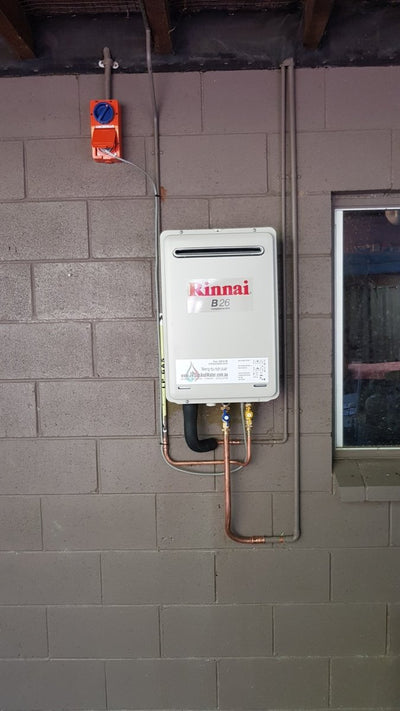 Rinnai B16 installed on a cement wall  | Featured image for Rinnai B16 (REU-A1624WB) + Installation Kit